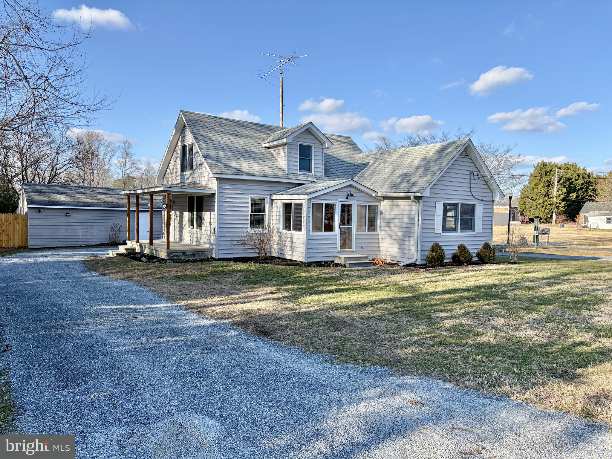 a view of a big house with a big yard and large trees