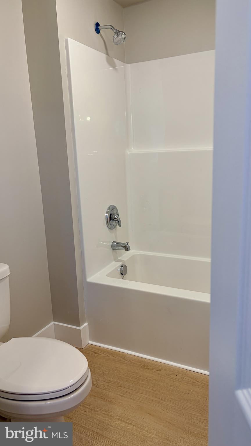 702 Federal Street Milton, DE 19968 - Photo 13 of 23 a bathroom with a toilet and a bath tub