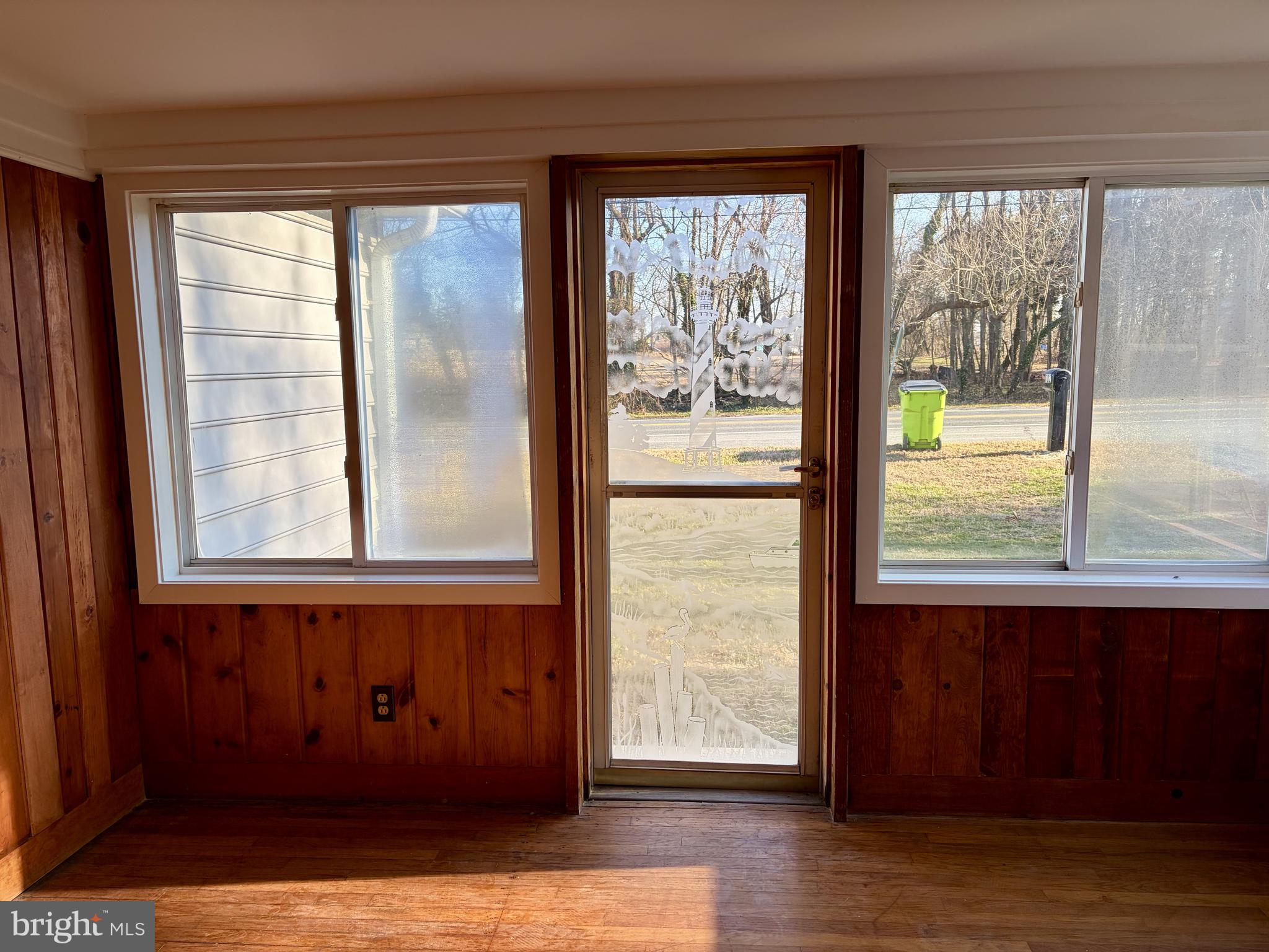 702 Federal Street Milton, DE 19968 - Photo 3 of 23 a view of a room that has a window and wooden floor