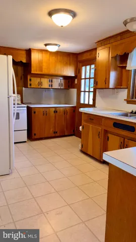 a kitchen with stainless steel appliances a sink and a refrigerator