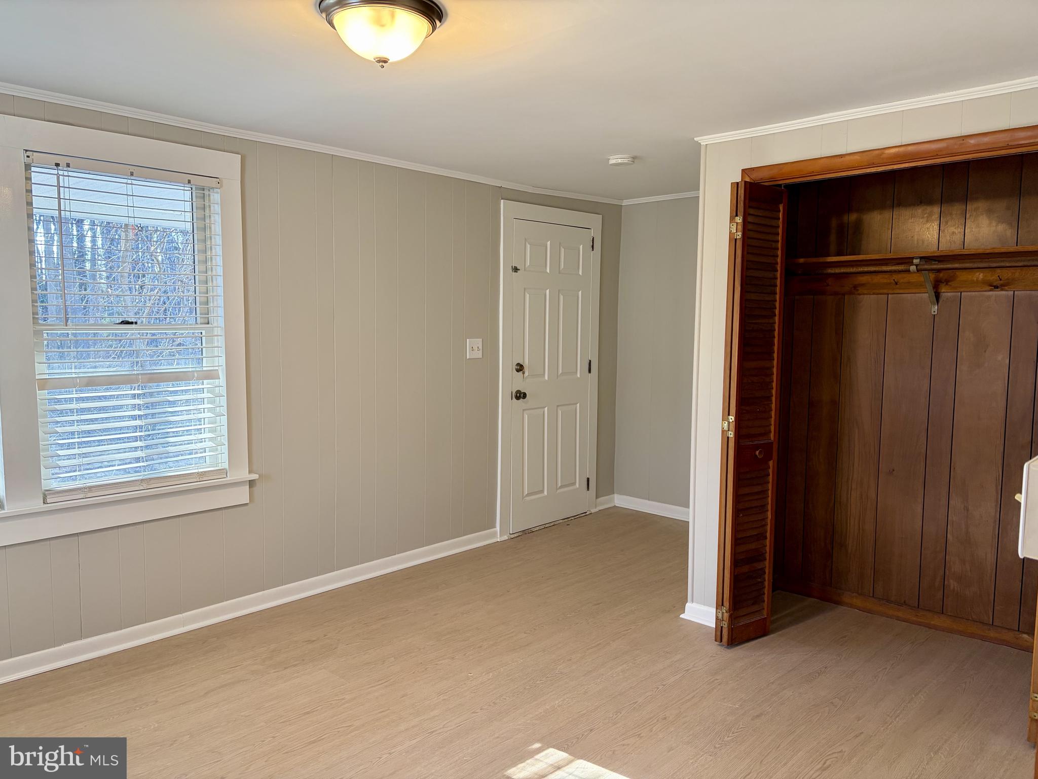 702 Federal Street Milton, DE 19968 - Photo 8 of 23 an empty room with windows and closet