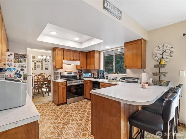 a kitchen with a sink a counter top space and stainless steel appliances