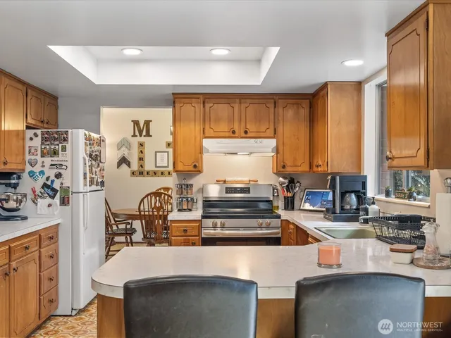a kitchen with stainless steel appliances a sink a stove and a refrigerator
