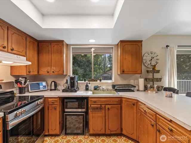 a kitchen with stainless steel appliances a sink stove and cabinets