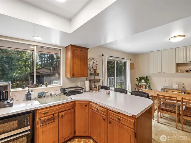 a kitchen with a sink stove and cabinets
