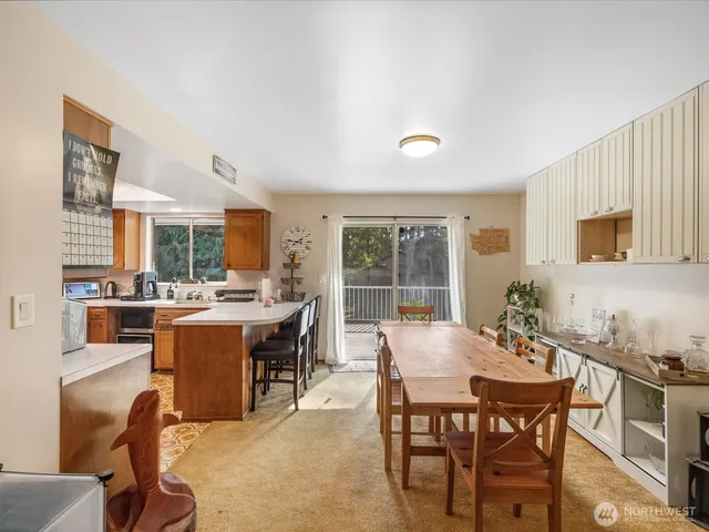 a view of a dining room with furniture and a window