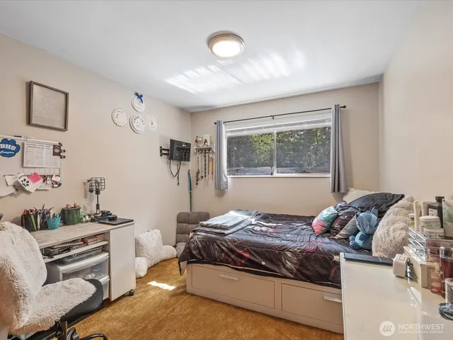 a bedroom with a bed and a window