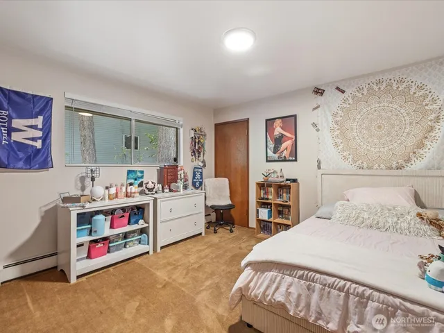 a bed room with a bed and a desk