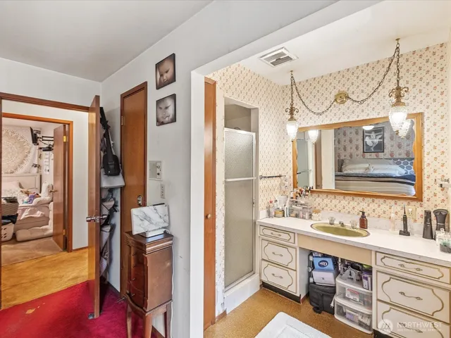 a bathroom with a double vanity sink a mirror and a shower