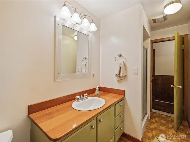a bathroom with a sink vanity and mirror