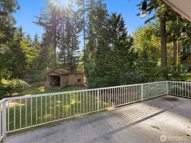 a view of a wooden fence and trees