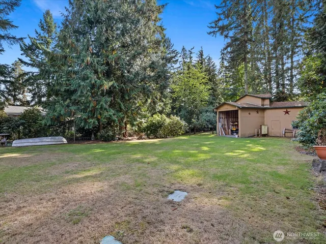 an aerial view of residential houses with city and green space