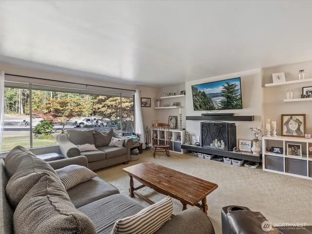 a living room with furniture large window and a flat screen tv