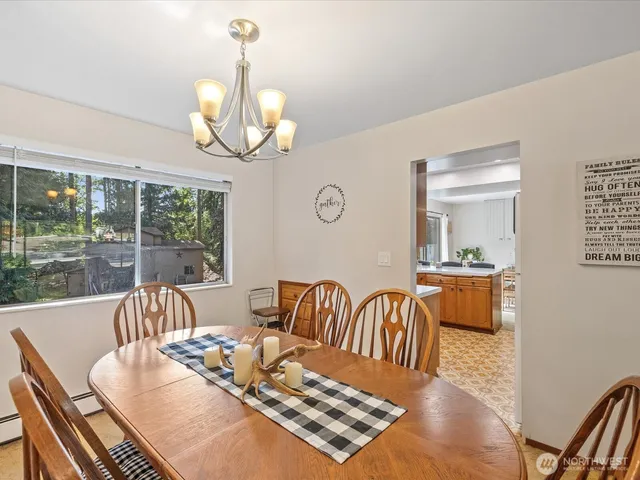 a view of a dining room with furniture wooden floor and a chandelier