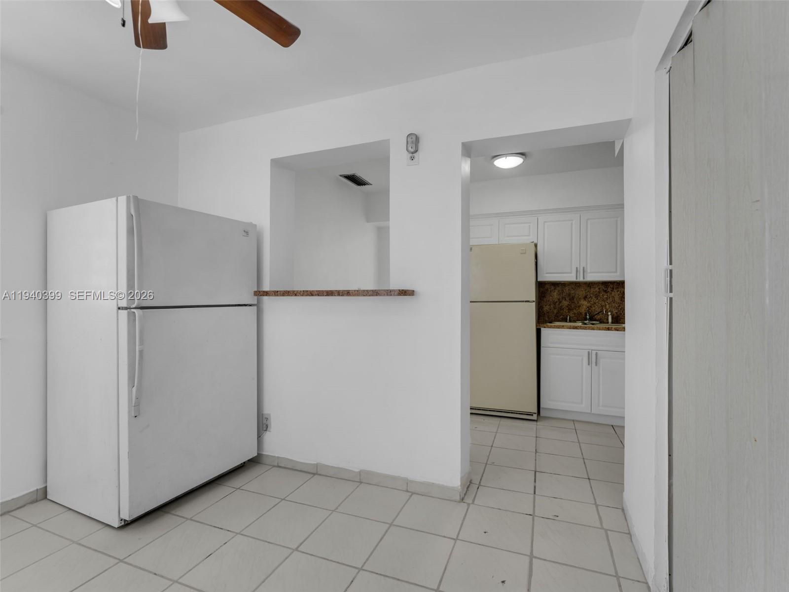 1811 Southwest 97th Terrace, Unit 2 Miramar, FL 33025 - Photo 11 of 29 a view of a refrigerator in kitchen and an empty room