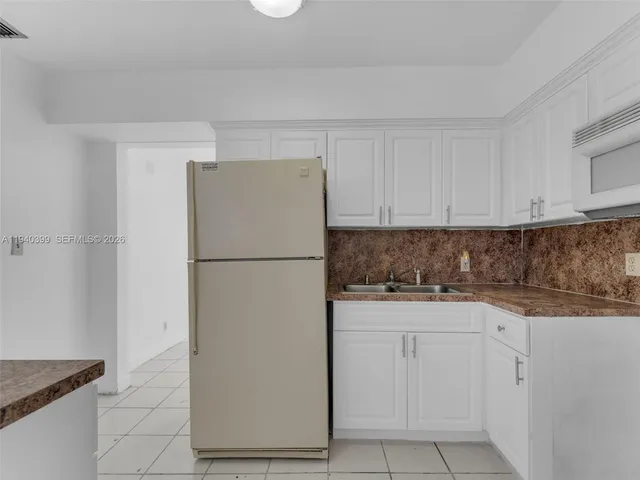 a bathroom with a granite countertop sink a mirror and a shower