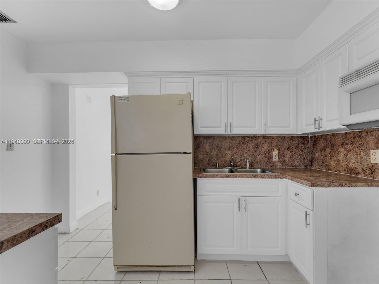 1811 Southwest 97th Terrace, Unit 2 Miramar, FL 33025 - Photo 13 of 29 a white refrigerator freezer sitting inside of a kitchen