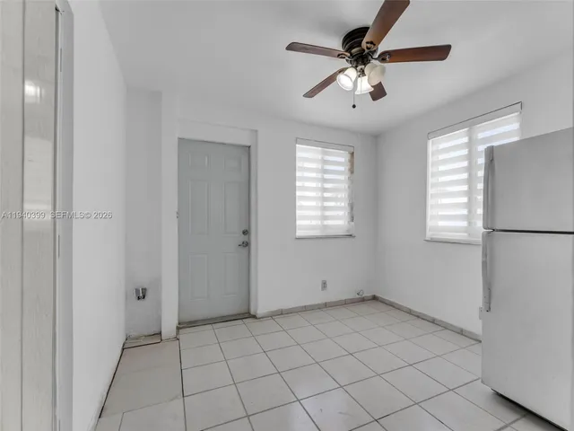 a view of a refrigerator and window in a kitchen