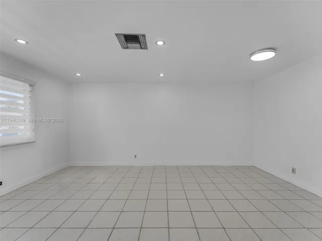 a kitchen with white cabinets and refrigerator