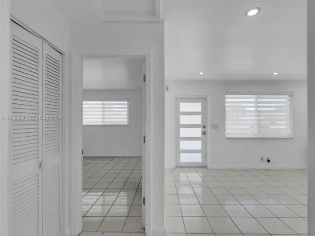 a bedroom with a bed and a potted plant