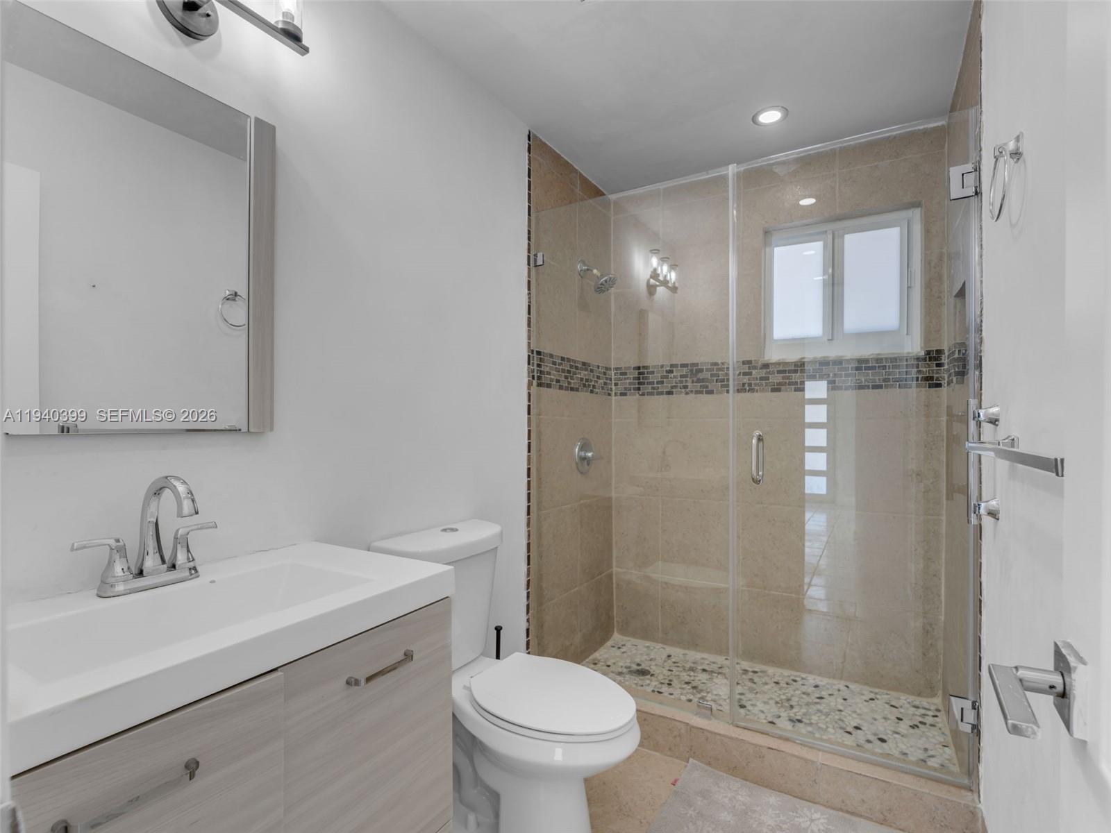 1811 Southwest 97th Terrace, Unit 2 Miramar, FL 33025 - Photo 26 of 29 a bathroom with a sink a toilet and shower