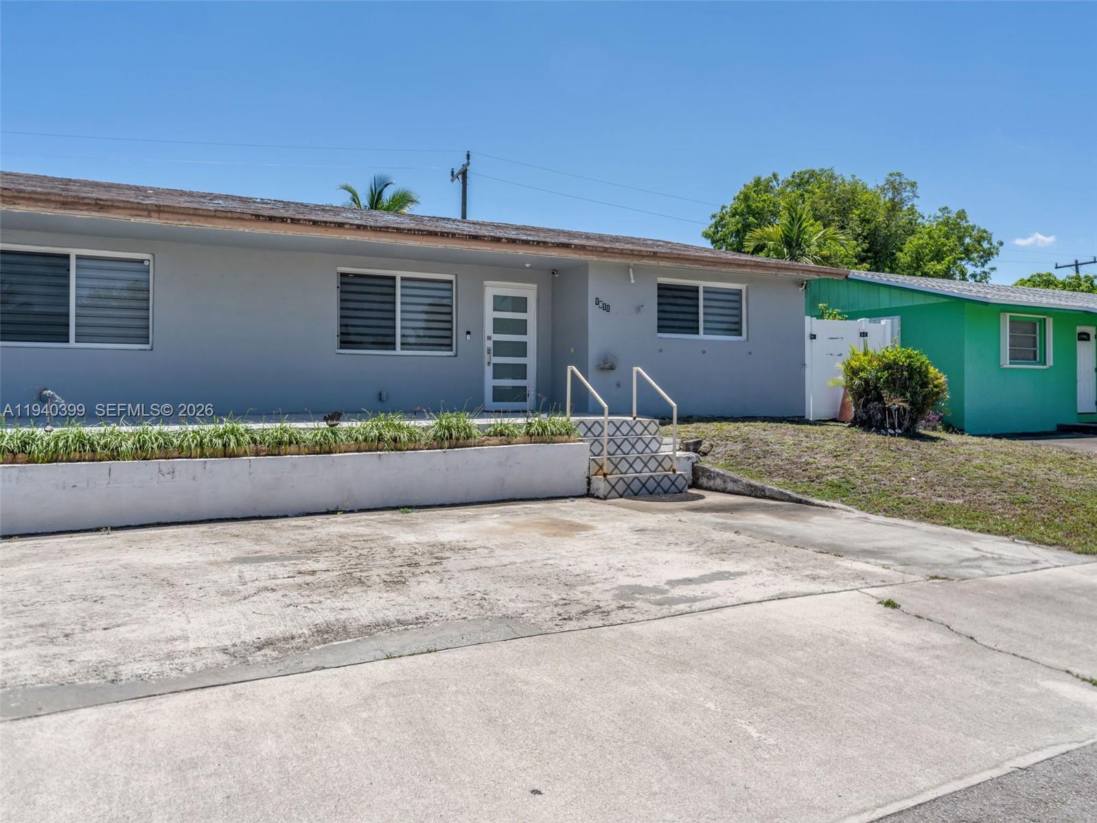 1811 Southwest 97th Terrace, Unit 2 Miramar, FL 33025 - Photo 5 of 29 front view of a house with a bench