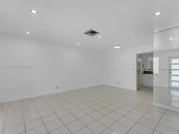 a living room with furniture a couch and a potted plant