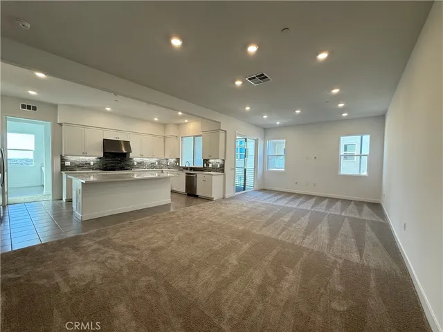 a view of a kitchen with a sink and dishwasher cabinets