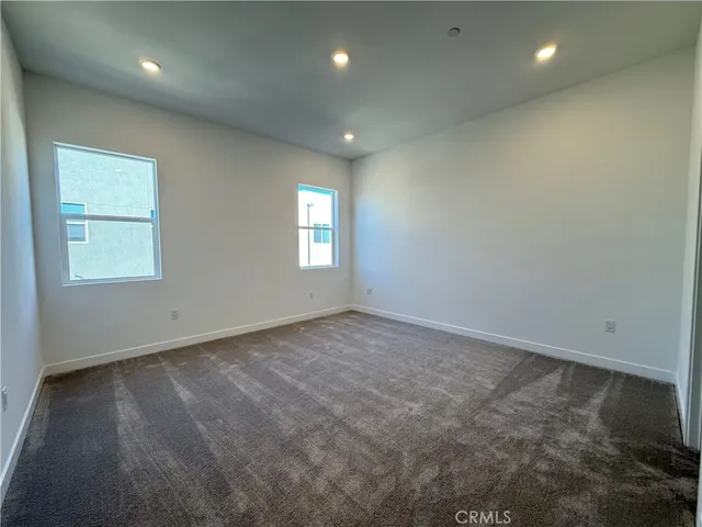 an empty room with closet and a window