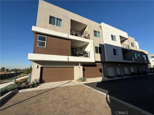a front view of a house with many windows