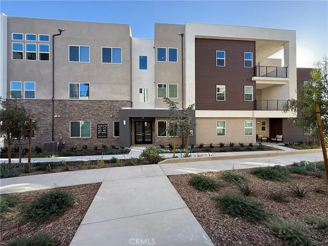 a front view of a building with a yard