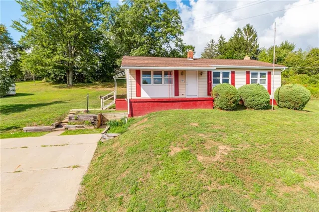 a view of a house with a yard porch and sitting area