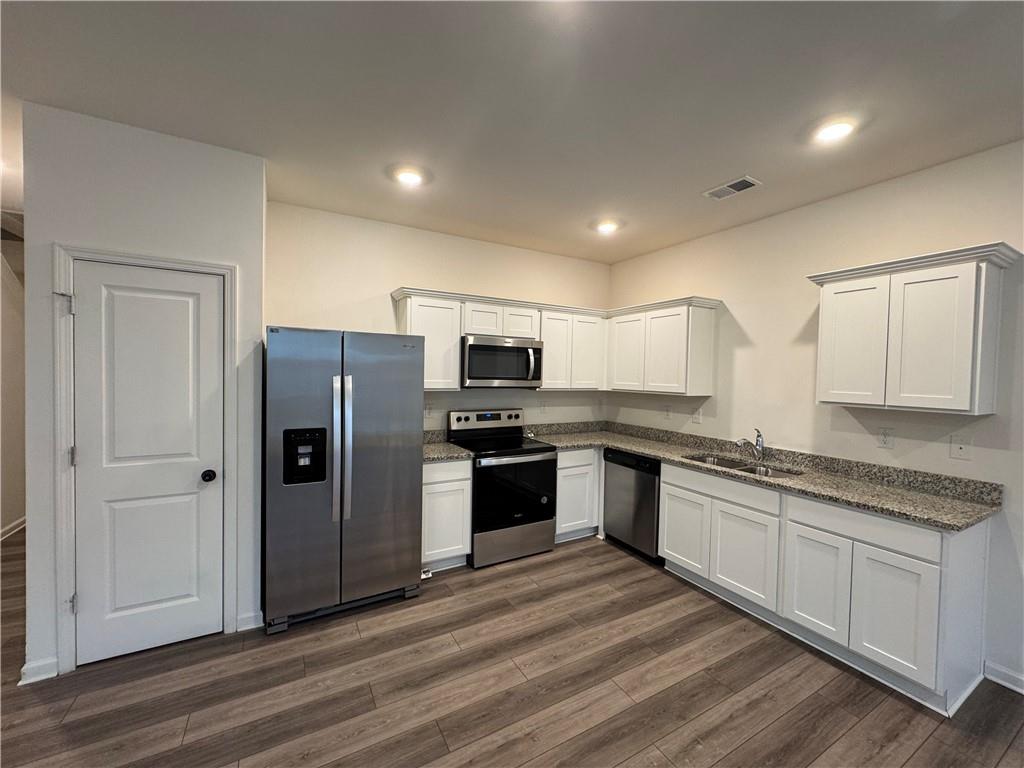 310 Penn Sta Way Cartersville, GA 30120 - Photo 3 of 10 a kitchen with stainless steel appliances granite countertop a refrigerator and a stove top oven