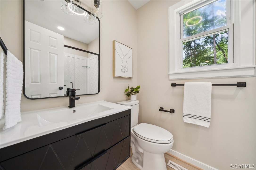 13914 Barnes Spring Road Midlothian, VA 23112 - Photo 21 of 33 a bathroom with a sink a toilet and mirror