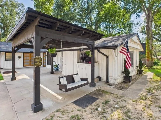 front view of a house with a yard and potted plants