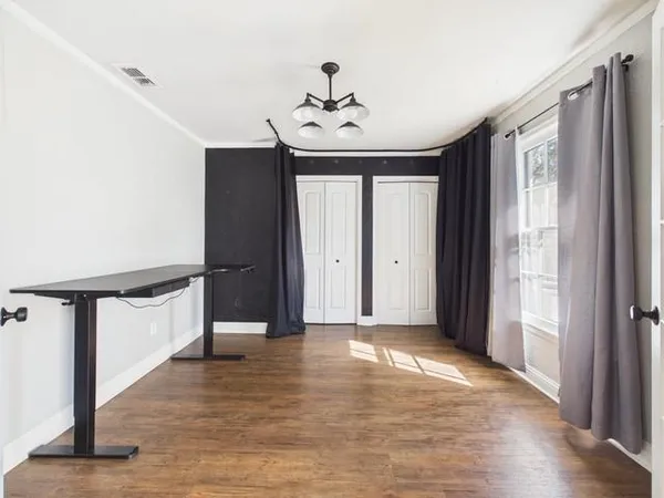 a living room with fireplace furniture and a wooden floor