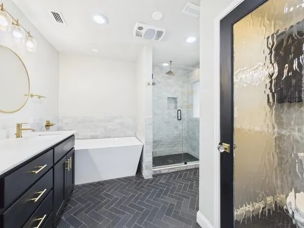 a bathroom with a double vanity sink and a bathtub