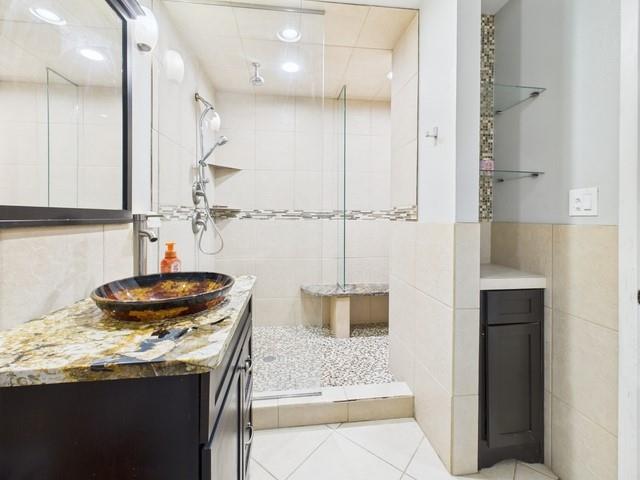 902 Ward Lane Athens, TX 75751 - Photo 20 of 40 a bathroom with a granite countertop sink a mirror and shower