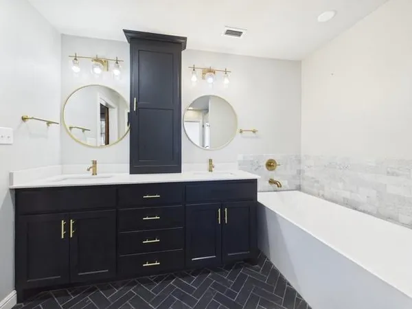 a very nice looking bedroom with a large bed a chandelier and a dresser