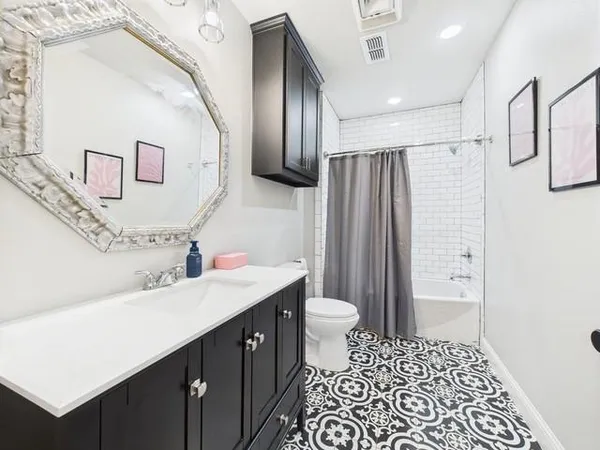 a view of a livingroom with a workspace wooden floor and a ceiling fan