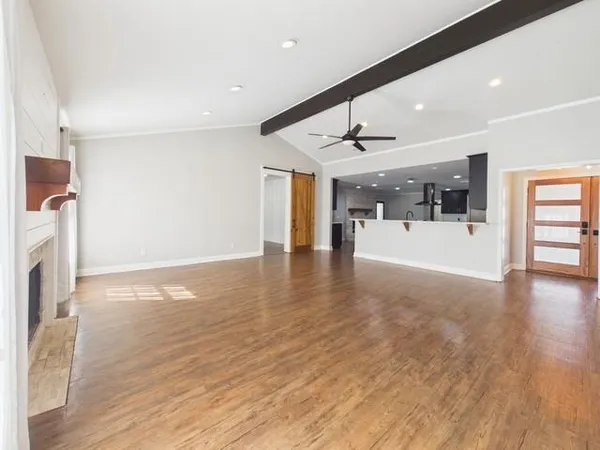 a view of a livingroom with a fireplace and window