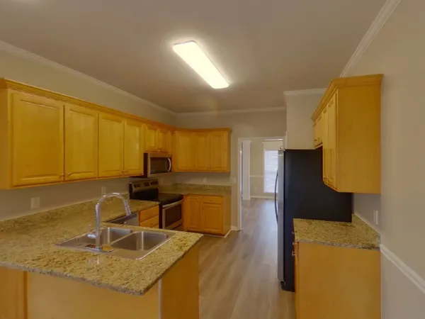 a kitchen with a sink and a refrigerator