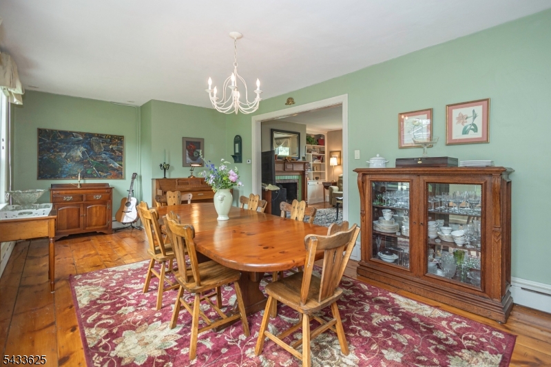 449 Stamets Road Milford, NJ 08848 - Photo 20 of 44 a view of a dining room with furniture a chandelier and wooden floor