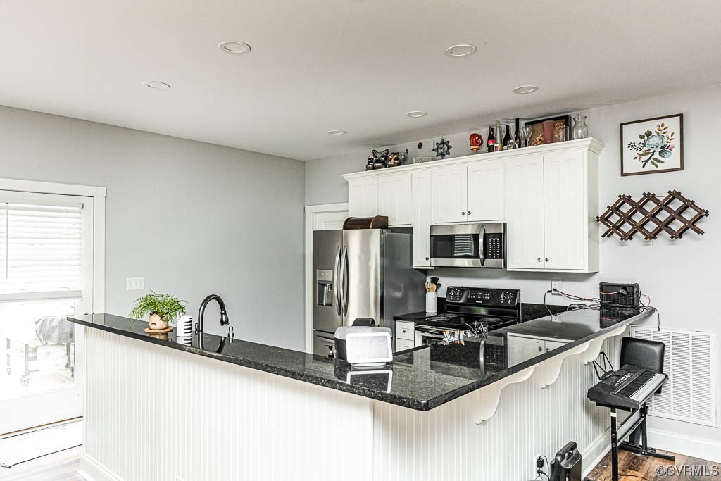 4111 Cedar Plains Road Sandy Hook, VA 23153 - Photo 13 of 28 a kitchen with stainless steel appliances a sink a stove a refrigerator cabinets and a dining table