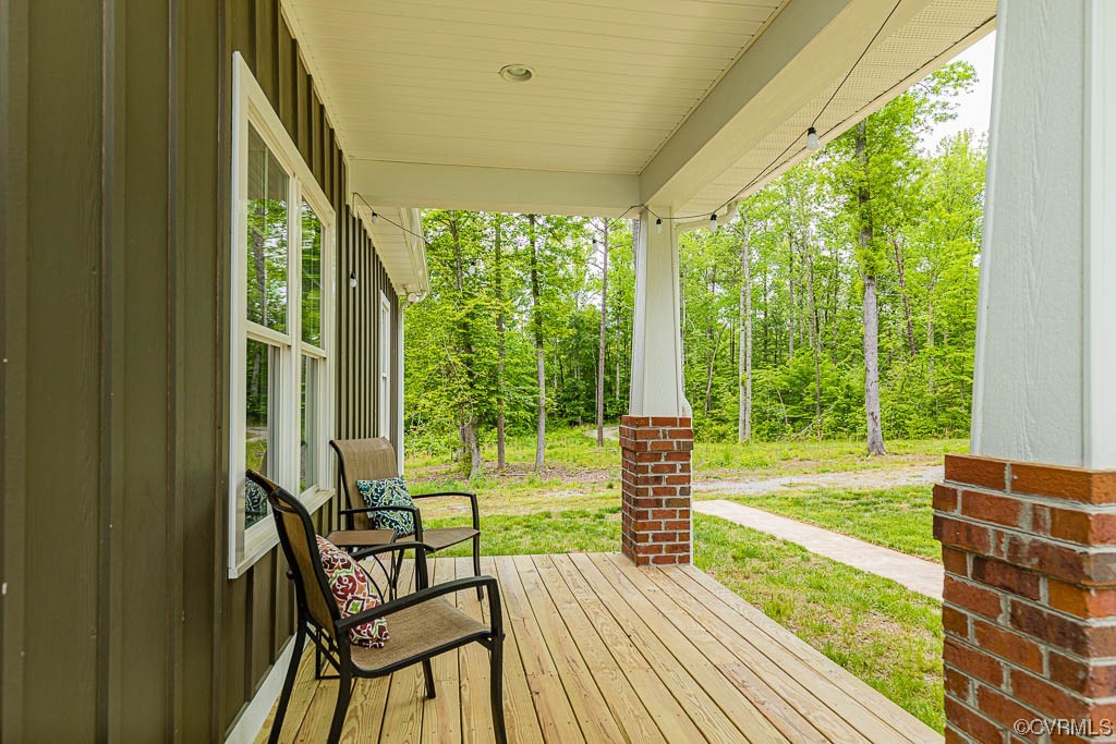 4111 Cedar Plains Road Sandy Hook, VA 23153 - Photo 2 of 28 a view of a porch with chairs and backyard
