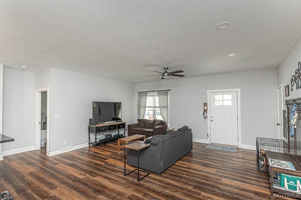 4111 Cedar Plains Road Sandy Hook, VA 23153 - Photo 5 of 28 a living room with furniture a flat screen tv and a fireplace