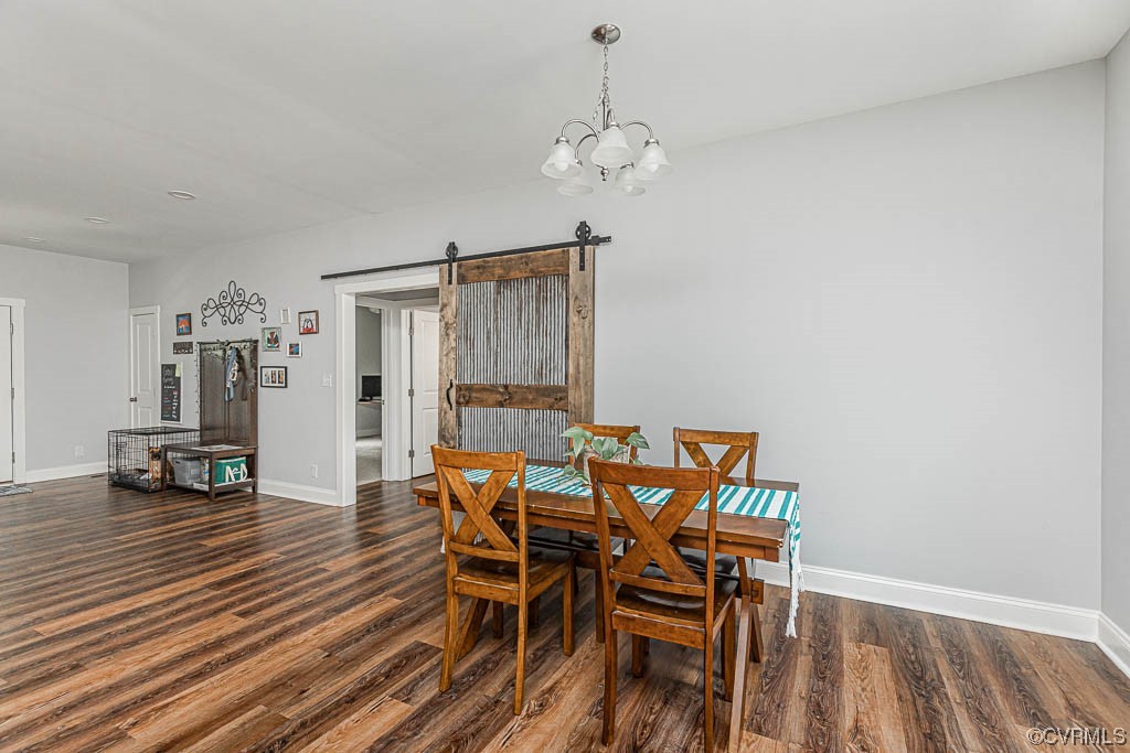 4111 Cedar Plains Road Sandy Hook, VA 23153 - Photo 10 of 28 a view of a dining room with furniture and wooden floor