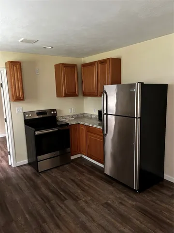 a kitchen with a refrigerator and a stove top oven