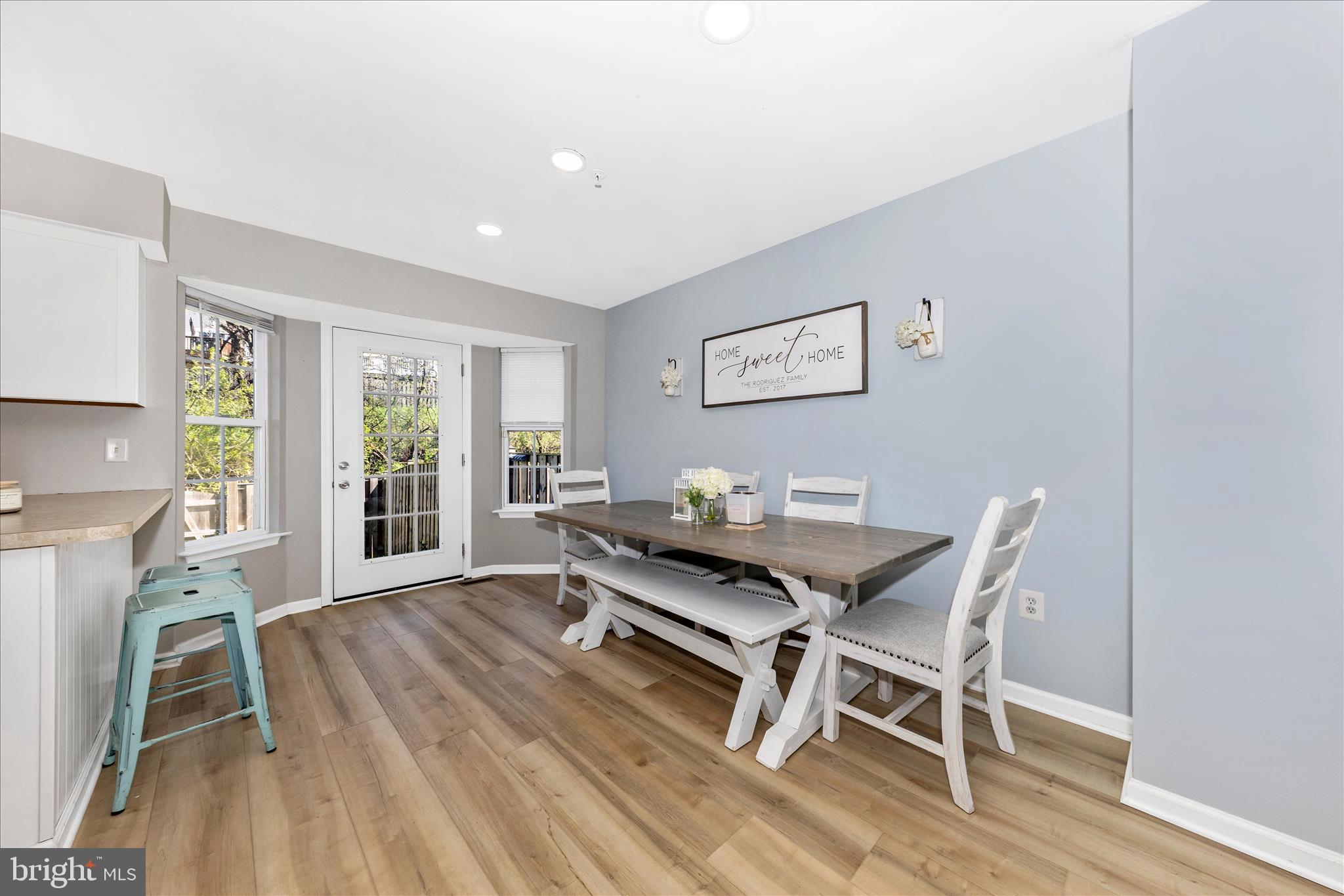 6107 Pine Ridge Terrace Frederick, MD 21701 - Photo 9 of 57 a view of a dining room with furniture wooden floor and a rug