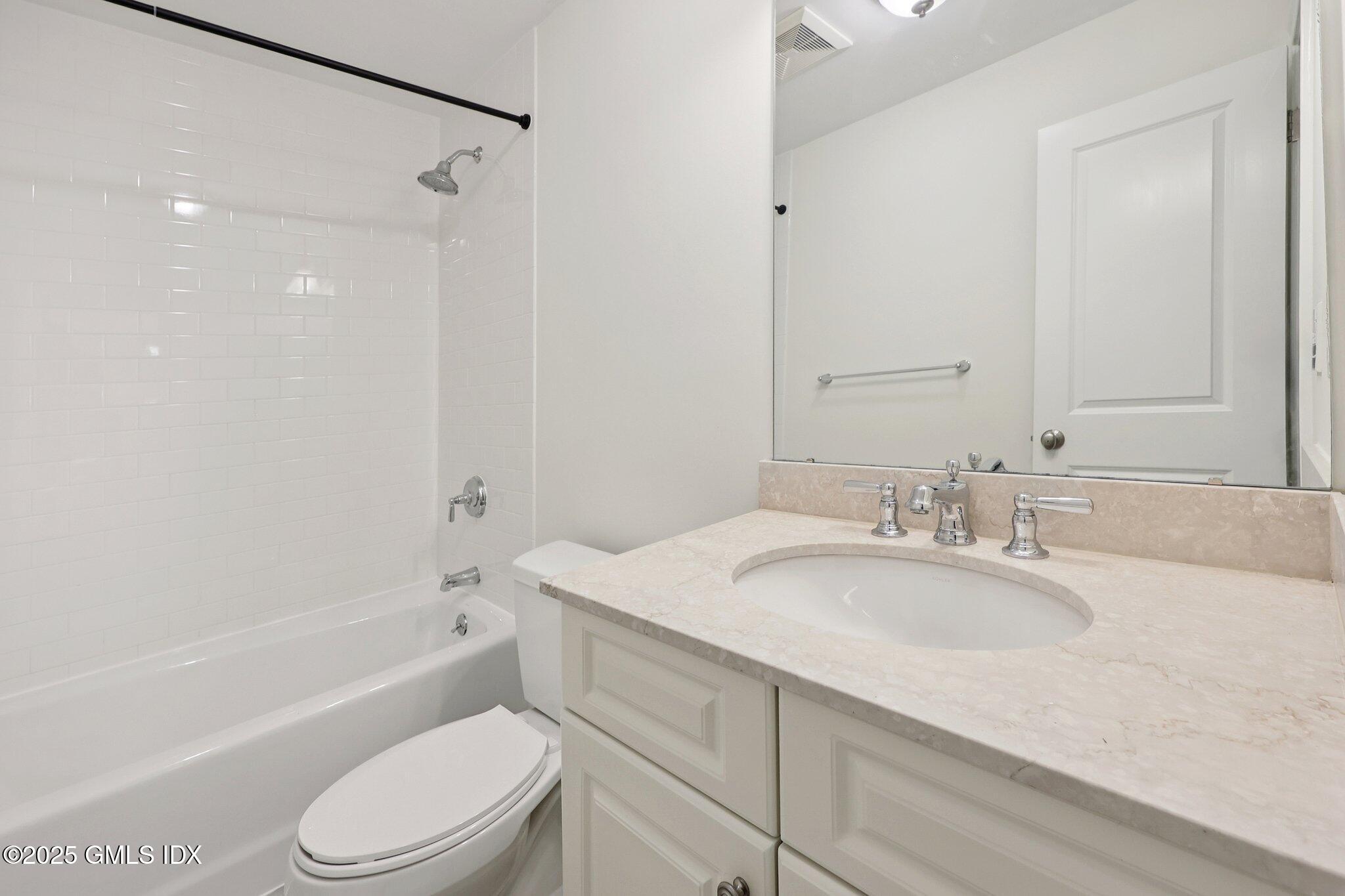 251 Weaver Street, Unit 1C Greenwich, CT 06831 - Photo 15 of 29 a bathroom with a granite countertop sink toilet and shower